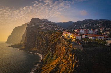 Sunset panorama of Camara de Lobos village in Madeira island, Portugal. October 2021. Aerial drone picture