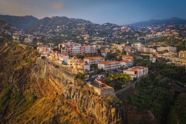 Sunset panorama of Camara de Lobos village in Madeira island, Portugal. October 2021. Aerial drone picture
