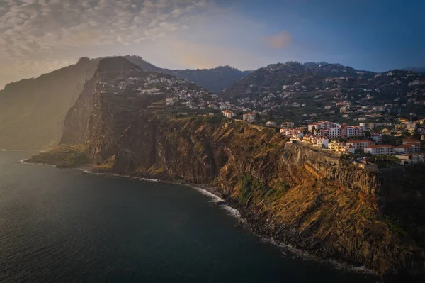 Sunset panorama of Camara de Lobos village in Madeira island, Portugal. October 2021. Aerial drone picture