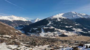 Arkasında karlı dağlar olan Bormio kasabası