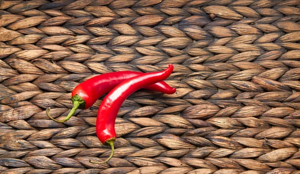 Red chili peppers on a wicker background — Stock Photo, Image