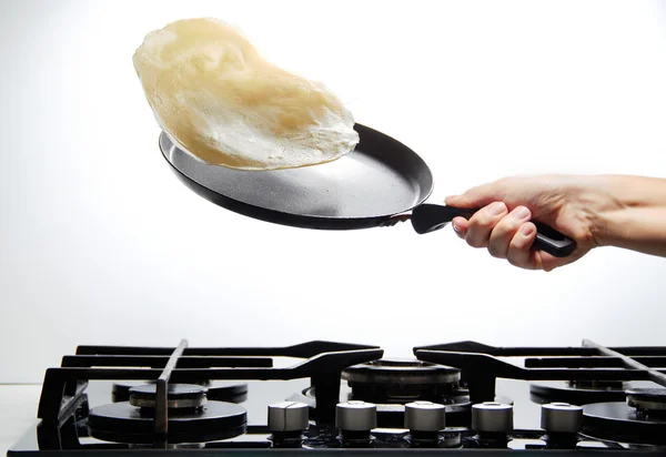 Frying pan with flying pancake — Stock Photo, Image