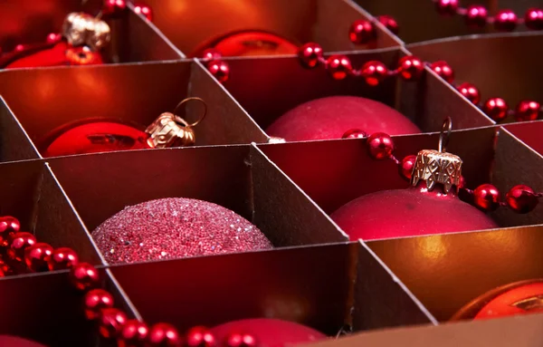 Golden and red christmas balls in box — Stock Photo, Image