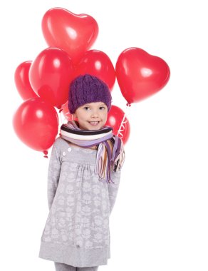 sevimli küçük kız elinde bir demet kırmızı kalpli balon