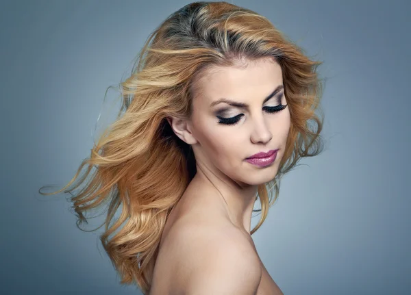 Beautiful young woman with blonde hair and evening make up — Stock Photo, Image