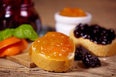 portakal ve Erik reçeli tahta masada ekmek dilimleri ile 