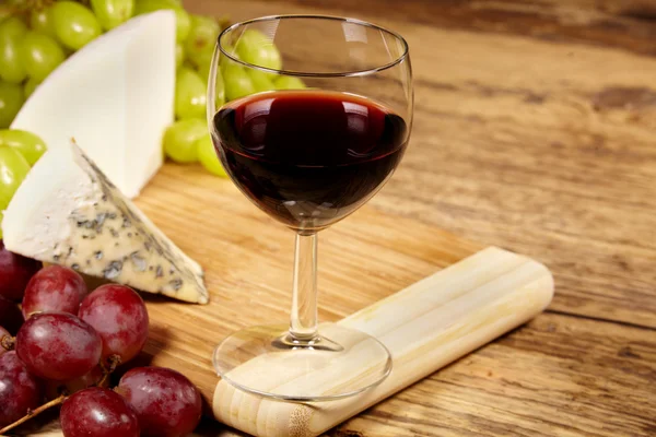 A red glass of wine and cheese Stock Picture