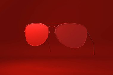 Kırmızı gözlüklü, kırmızı arka planda yüzüyor. Asgari konsept fikir yaratıcı. Tek renk olsun. 3 Boyutlu Hazırlama.