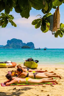 Many women sunbathing, Mahya bay, Krabi Thailand clipart