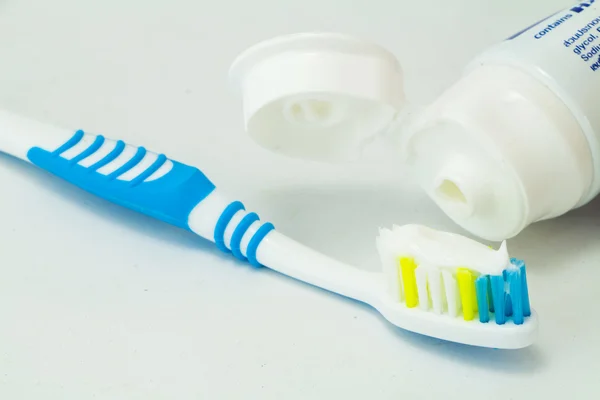 Toothbrush and toothpaste tubes — Stock Photo, Image