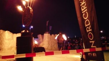 Ostersund, İsveç, 12 Mart 2022: Şehirde buz ve kar arasında meşaleler ve dumanla akşam şovu.