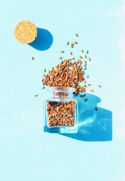 Linseed Spilling Out Jar Light Blue Background — Stock Photo, Image