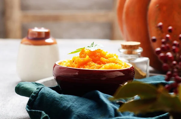 Pumpkin puree mashed in a red bowl.