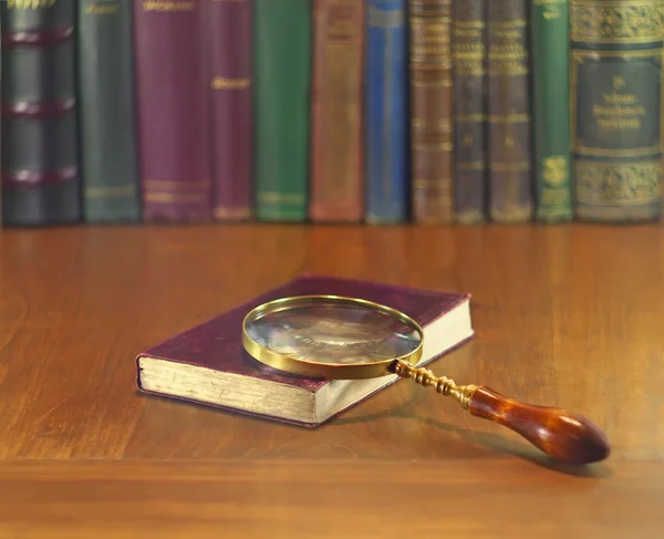 Magnifier and book — Stock Photo, Image