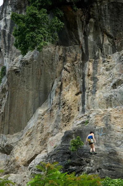 Woman climbing mountain