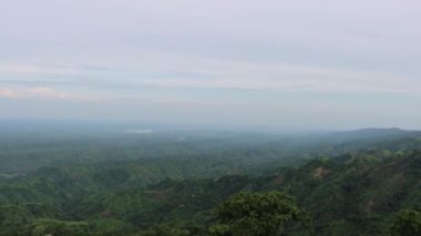 Hill and sky horizon footage with a drone. Slow Motion 4K view of mountains and cloudy sky horizon. Aerial drone shot of a mountain area. Landscape mountain view with cloudy sky and green hills.