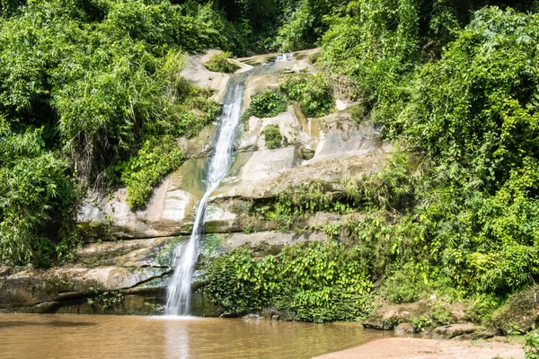 Beautiful waterfall photography with green trees. rocky hill waterfall photo with small river flow in a tropical forest. Beautiful natural view with a rocky mountain and waterfall.