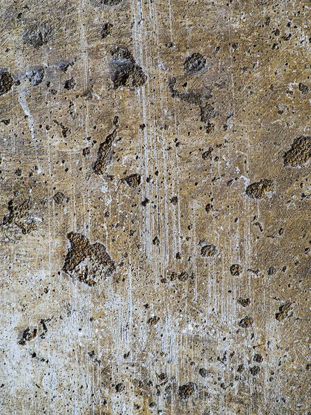 Textured concrete background with many potholes, scratches, irregularities, scuffs with colored traces. Vertical — Stock Photo, Image