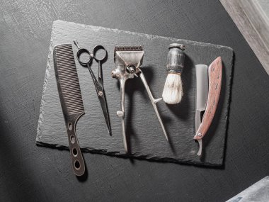 vintage barber tools dangerous razor hairdressing scissors old manual clipper comb shaving brush. on a black