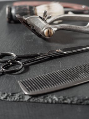 vintage barber tools dangerous razor hairdressing scissors old manual clipper comb shaving brush. on a black
