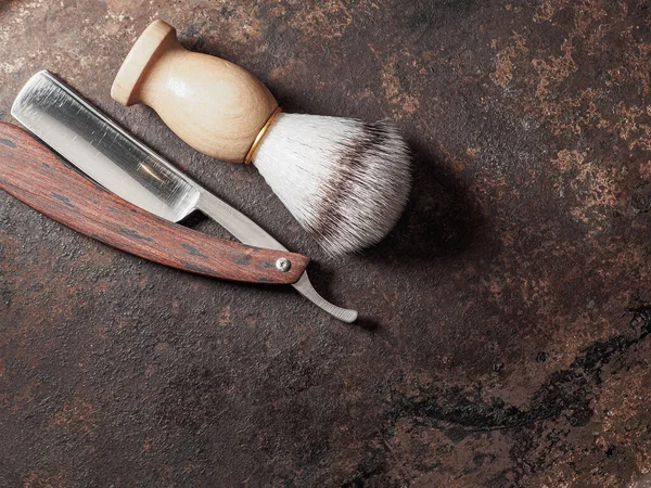 vintage barber tools. dangerous razor manual shaving brush. rusty background. top view flat lay