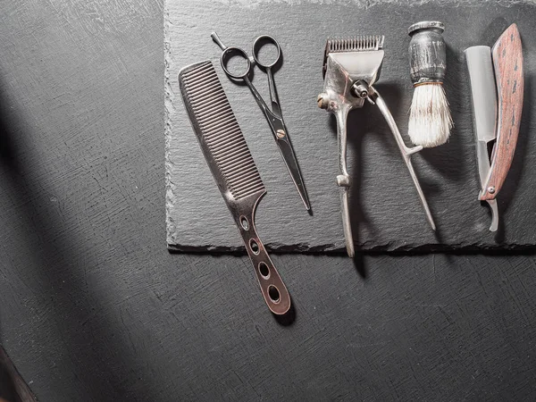 vintage barber tools dangerous razor hairdressing scissors old manual clipper comb shaving brush. on a black