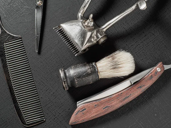Vintage barber tools dangerous razor hairdressing scissors old manual clipper comb shaving brush. on a black — Fotografia de Stock