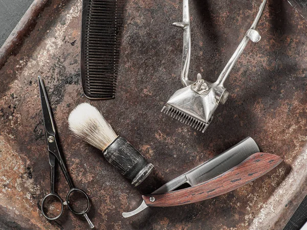 Vintage barber tools dangerous razor hairdressing scissors old manual clipper comb shaving brush. Stock Image