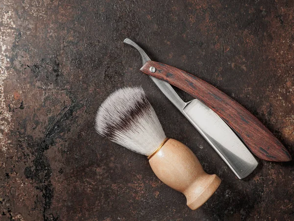 vintage barber tools. dangerous razor manual shaving brush. rusty background. top view flat lay