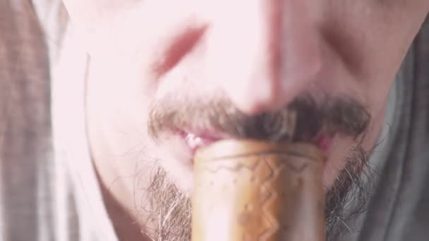Bearded caucasian man lighting a bong smoking pipe — Stock Video