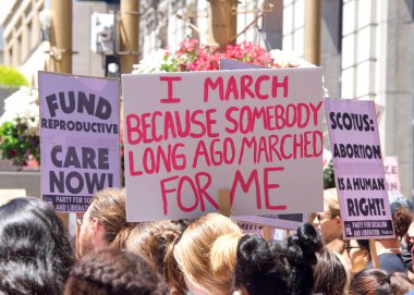 San Francisco, CA - May 7, 2022: Unidentified Participants holding signs marching in San Francisco at Women's Rights Protest after SCOTUS leak plan to overturn Roe v Wade. 
