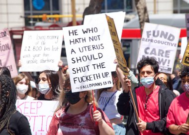 San Francisco, CA - May 7, 2022: Unidentified Participants holding signs marching in San Francisco at Women's Rights Protest after SCOTUS leak plan to overturn Roe v Wade. 