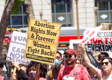 San Francisco, CA - May 7, 2022: Unidentified Participants holding signs marching in San Francisco at Women's Rights Protest after SCOTUS leak plan to overturn Roe v Wade.