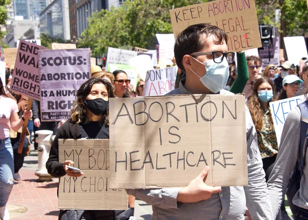 San Francisco, CA - May 7, 2022: Unidentified Participants holding signs marching in San Francisco at Women's Rights Protest after SCOTUS leak plan to overturn Roe v Wade. 