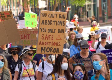 San Francisco, CA - May 14, 2022: Unidentified participants marching in the streets holding signs in support of Reproductive Justice and a Womans Right to Choose. 