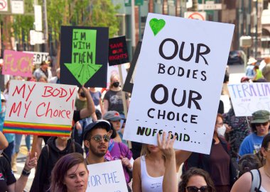 San Francisco, CA - May 14, 2022: Unidentified participants marching in the streets holding signs in support of Reproductive Justice and a Womans Right to Choose. 