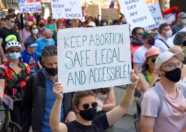 San Francisco, CA - May 14, 2022: Unidentified participants marching in the streets holding signs in support of Reproductive Justice and a Womans Right to Choose.