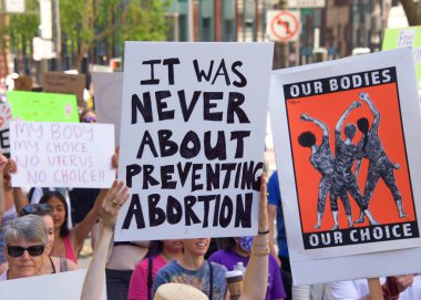 San Francisco, CA - May 14, 2022: Unidentified participants marching in the streets holding signs in support of Reproductive Justice and a Womans Right to Choose. 