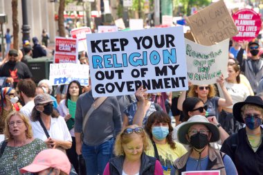 San Francisco, CA - May 14, 2022: Unidentified participants marching in the streets holding signs in support of Reproductive Justice and a Womans Right to Choose. 