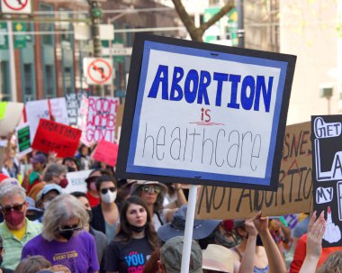 San Francisco, CA - May 14, 2022: Unidentified participants marching in the streets holding signs in support of Reproductive Justice and a Womans Right to Choose. 