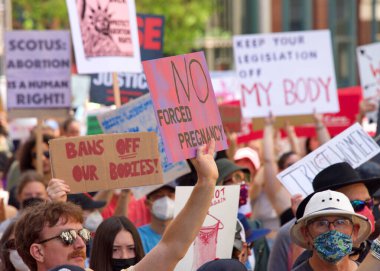 San Francisco, CA - May 14, 2022: Unidentified participants marching in the streets holding signs in support of Reproductive Justice and a Womans Right to Choose. 