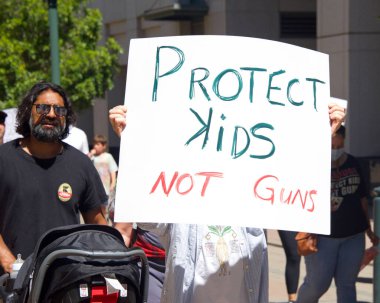 Oakland, CA - 11 Haziran, Mart 'ta Frank H Ogawa Plaza' nın etrafında yürüyüp silahlı şiddete karşı eylem talep eden tanımlanamayan katılımcılar.