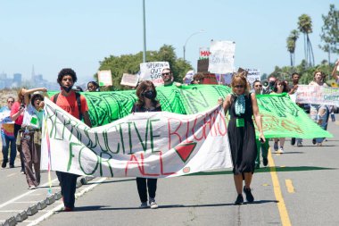 Alameda, CA - July 10, 2022: Youth Led Protesters holding signs protesting SCOTUS overturning Roe, removing abortion rights. Yelling while marching  to City Hall for a rally.