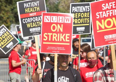 Oakland, CA - August 22, 2022:  Mental Health Care workers protesting outside Kaiser Medical Center on Broadway. Demanding Patient health be prioritized over corporate wealth. Patients before profits