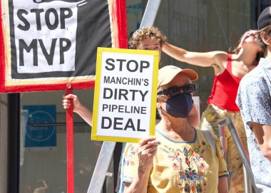 San Francisco, CA - Sept 1, 2022: Unidentified protestors holding signs, protesting the dirty pipeline deal outside Senator Feinsteins office.