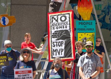 San Francisco, CA - Sept 1, 2022: Unidentified protestors holding signs, protesting the dirty pipeline deal outside Senator Feinsteins office.