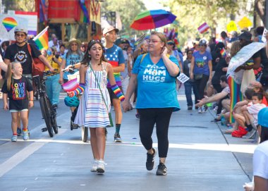 Oakland, CA - Sept 4, 2022:  Unidentified participants celebrate at the Oakland Gay Pride Parade on Broadway, downtown Oakland. Back to in person celebrations post covid pandemic restrictions.