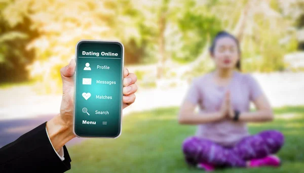 Hand hold smartphone with health app on the screen. All screen graphics are made up, health app while walking in nature park, Exercise for health or warm-up body, Oxygen in the green tree in the park