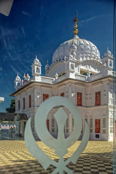 22 Dec 2010 Khanda (Sikh symbol) Shot thru Glass Panel Gurudwara Nanak Jhira Sahib dedicated to the first Sikh guru Guru Nanak Bidar Karnataka India