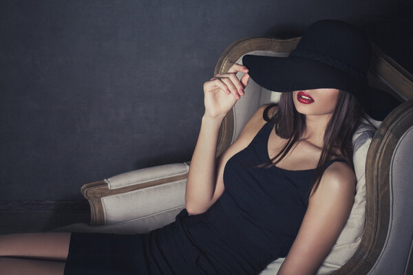 Elegant sexy lady with red lips wearing hat